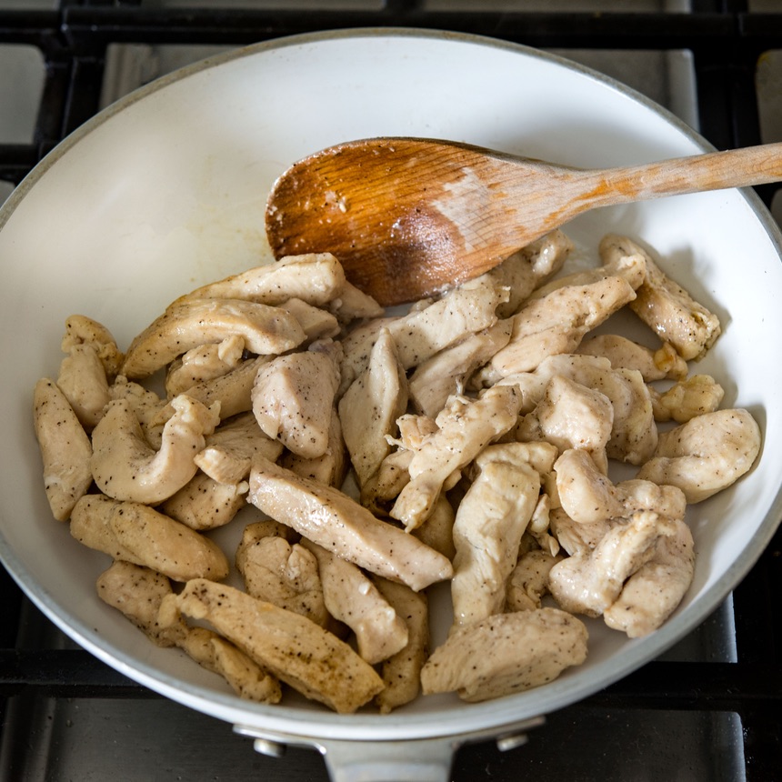 chicken sauteing in pan