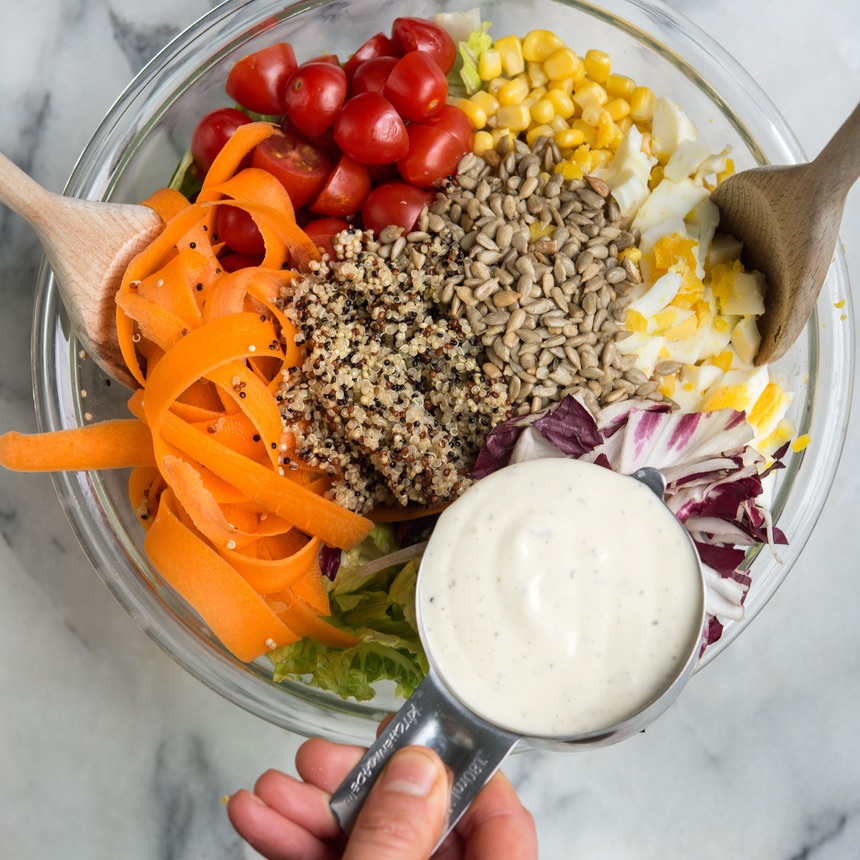 ranch dressing poured into salad