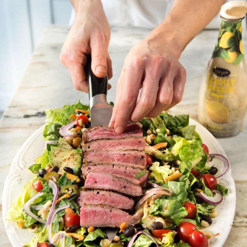 arrange steak on salad