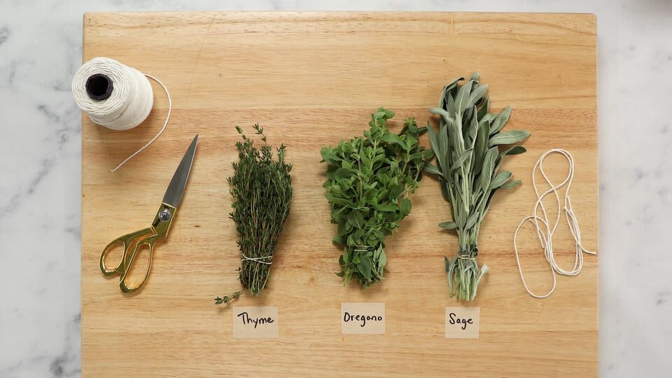 Fresh herbs stored in a jar of water in the fridge